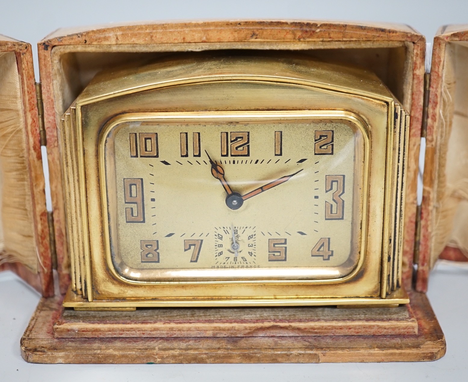 A cased Art Deco brass travelling timepiece